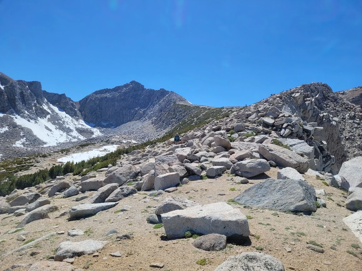 Granite, lingering snow, and the view from the col.